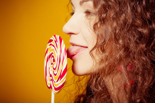 happy young woman with lollipop