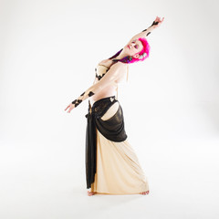 Pink haired belly dancer on white background in a studio shot.