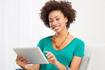 Naklejka na ściany i meble African Woman Looking At Digital Tablet