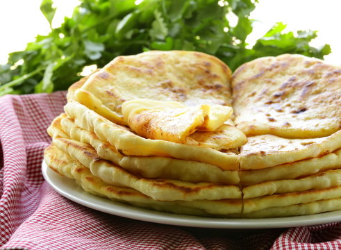 pile of fried bread with butter and parsley