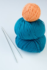 Two skeins of yarn and a turquoise orange yarn