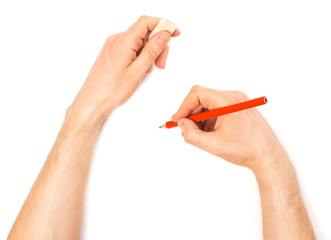 Human hands with pencil and erase rubber writting something