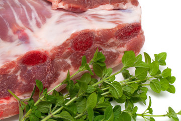 piece of pork ribs and marjoram herb
