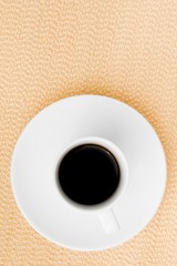 dark espresso in a cup on burlap surface
