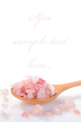 Sea salt poured from wooden spoon