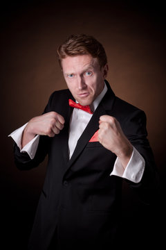 elegant man in a tuxedo with a red bow