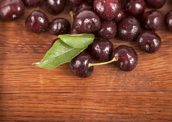 Red, ripe, juicy cherries on wooden boards