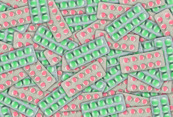 Green and pink pills in blister