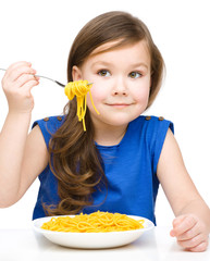 Little girl is eating spaghetti