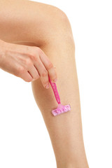 Beautiful woman is shaving her leg, isolated on white