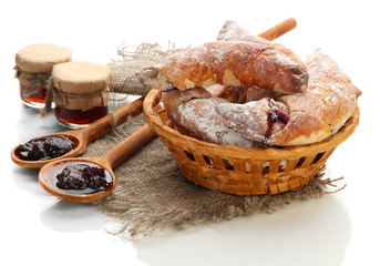 Taste croissants in basket and jam isolated on white.