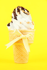 Tasty ice cream with chocolate, on yellow background