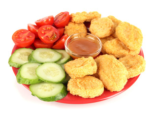 Fried chicken nuggets with vegetables and sauce isolated