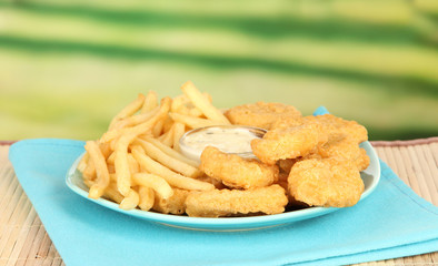 Fried chicken nuggets with french fries and sauce
