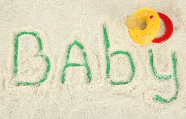 Word baby making with powdered milk on green background