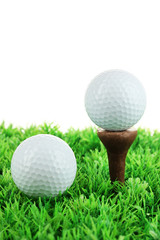 Golf balls on grass isolated on white