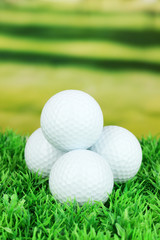 Golf balls on grass outdoor close up