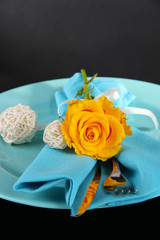 Served plate with napkin and flowers close-up