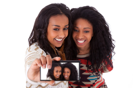 Young black african american teenage girls taking pictures with