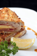 Chicken cordon bleu on black background