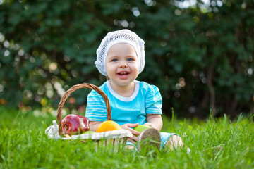 cute baby girl sitting ion the grass