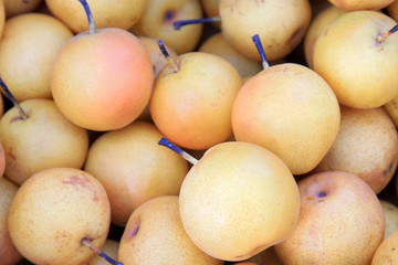 pears are stacked together in a market