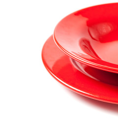 Colorful red ceramics plates on white background