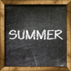 Fototapeta premium Summer handwritten with white chalk on a blackboard.