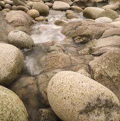 Water worn ancient rocks detail on secluded beach