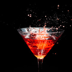 red splashing cocktail on black