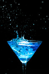 blue splashing cocktail on black