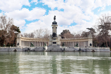 Fototapeta na wymiar Monument to Alfonso XII and colonnade near pond in Retiro Park