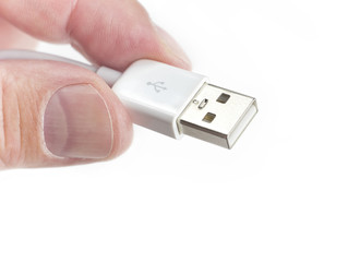fingers holding usb connector closeup