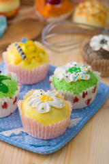 cupcakes muffins with cream fuits , breads, chocolate variety an