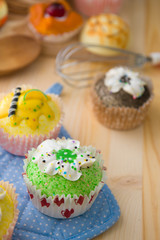 cupcakes muffins with cream fuits , breads, chocolate variety an