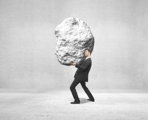businessman holding rock 