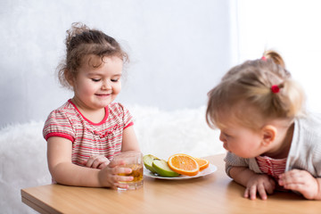 children eating healthy food in kitchen