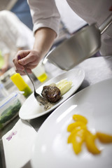 Chef in restaurant kitchen cooking, only hands to be se - 51439831
