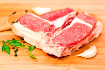 Raw beef with spices and vegetables on the cutting board