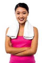 Fit smiling woman with towel around her neck