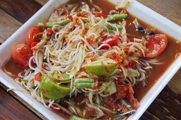 Thai noodles and papaya salad in foam plate