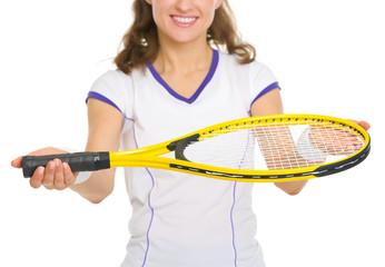 Closeup on smiling female tennis player giving racket