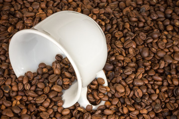 White cup with many coffee beans