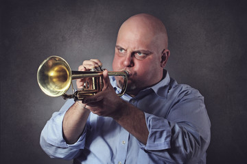 Man with strong expression plays a trumpet © captblack76