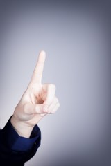 Woman's hand with finger, blue background