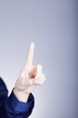 Woman's hand with finger, blue background