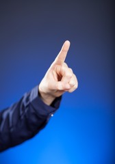 Woman's hand with finger, blue background