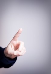 Woman's hand with finger, dark background