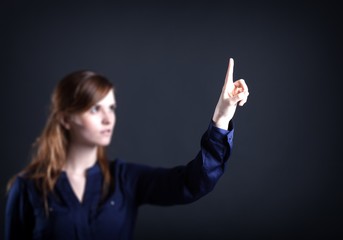 Woman's hand with finger, dark background