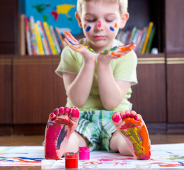 Boy with colorful  painted hands and foot